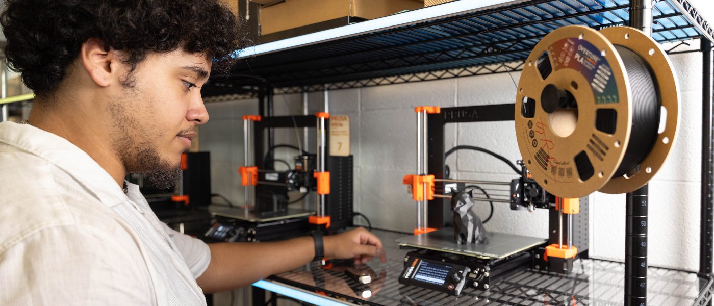 Student working at 3D printer